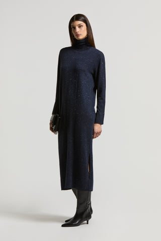 woman with a long wool blue dress with lurex and long sleeves, high neck