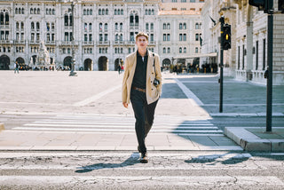 man with old vintage photocamera walking in trieste historic center