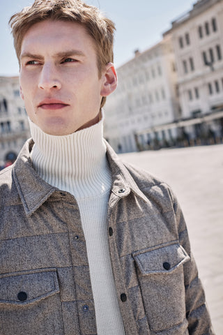 portrait of male model with high neck jumper and brown down jacket