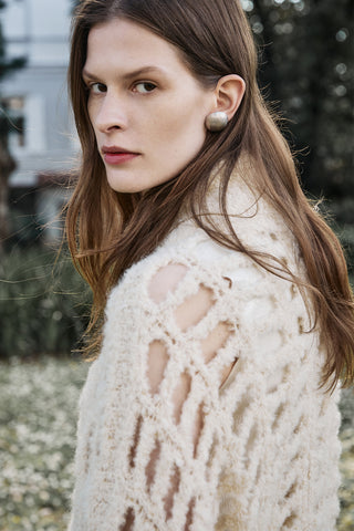 portrait of a woman with long hair and alpaca meshed cardigan